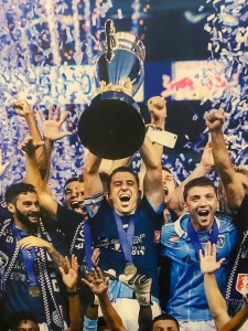 Matt Besler lifts the Lamar Hunt U.S. Open Cup for Sporting KC.