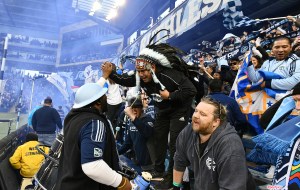 Sporting KC fan Hector Solorio celebrates a goal with fellow supporters in the KC Cauldron.